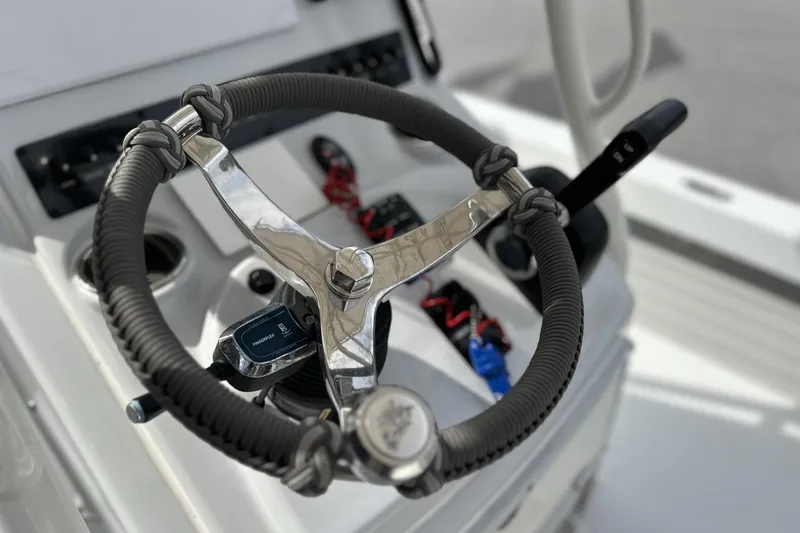 Slide: The Image of Steering wheel of 2024 Pathfinder 2200 TRS boat, featuring modern controls and design. - 3