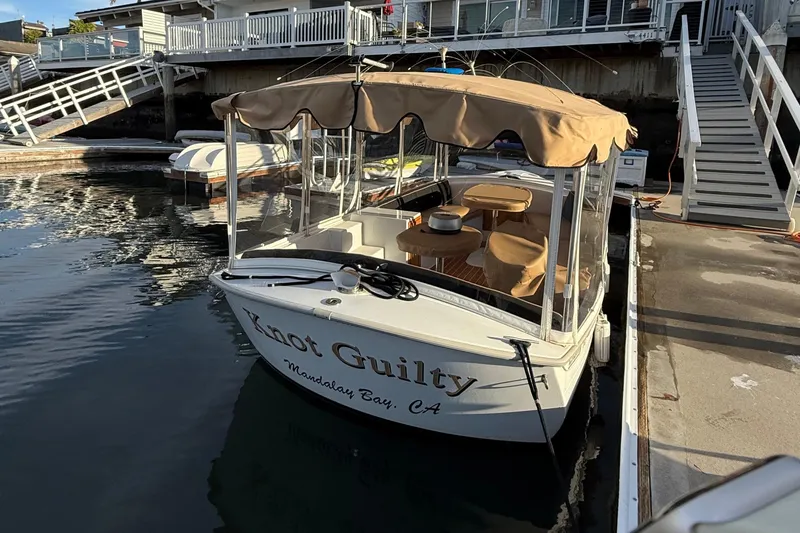Slide: The Image of 2022 Duffy 16 boat named "Knot Guilty" docked at Mandalay Bay, CA. - 4