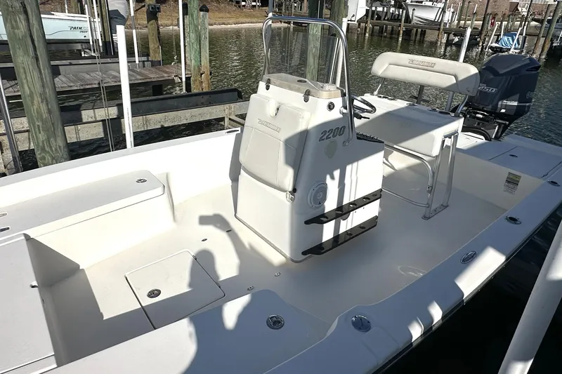 Slide: The Image of 2012 Pathfinder 2200 Tournament Edition boat docked, featuring a clean deck and seating area. - 11