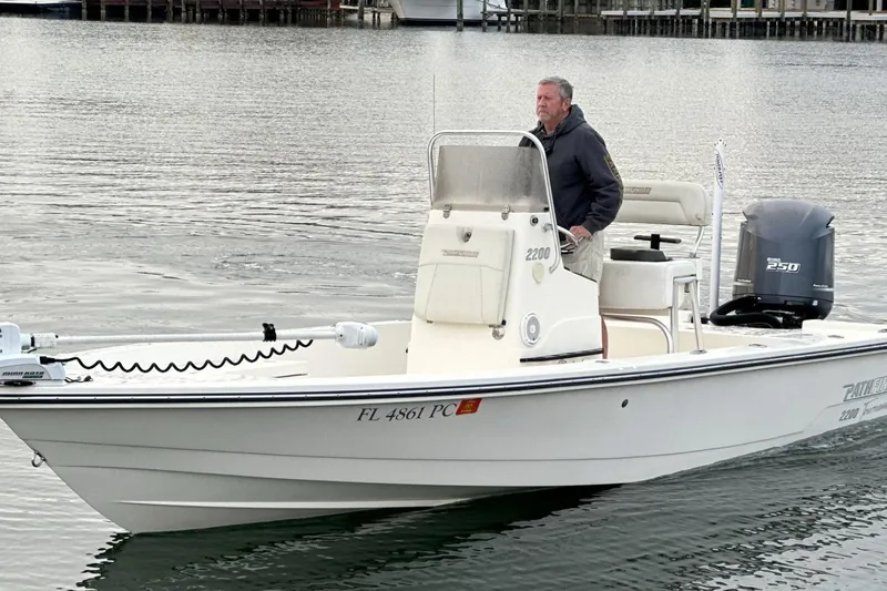 Slide: The Image of Man operating 2012 Pathfinder 2200 Tournament Edition boat on calm water. - 4