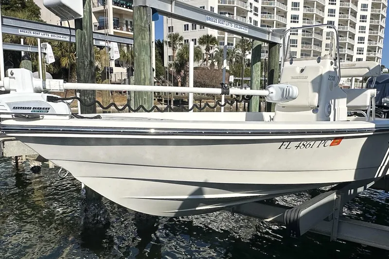 Slide: The Image of 2012 Pathfinder 2200 Tournament Edition boat on lift near waterfront buildings. - 7