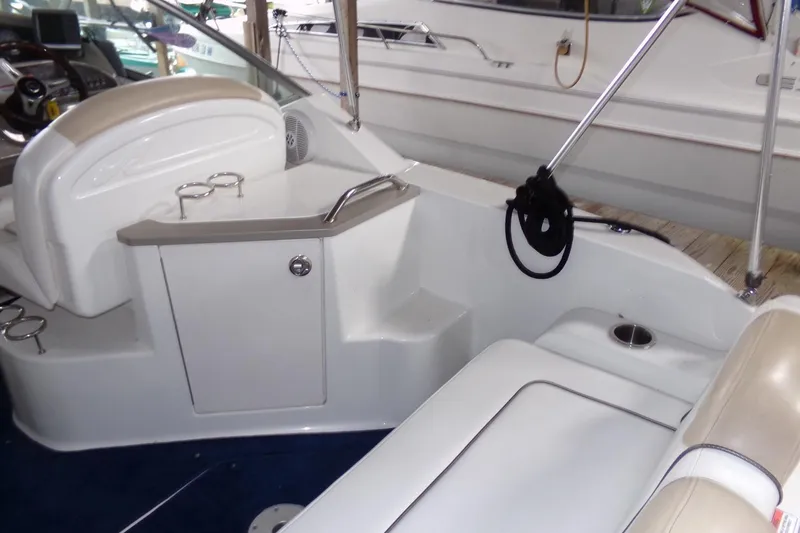 Slide: The Image of 2009 Searay Sundancer boat interior with seating and cup holders. - 11