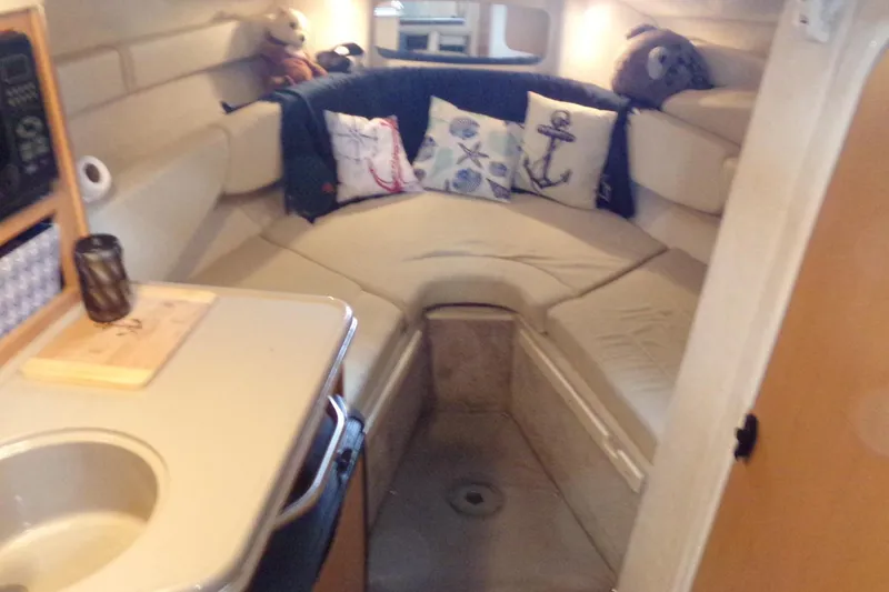 Slide: The Image of 2009 Searay Sundancer cabin interior with cozy seating and nautical-themed decor. - 12
