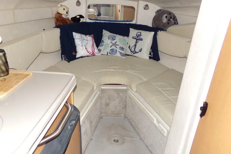 Slide: The Image of 2009 Searay Sundancer cabin interior with nautical-themed pillows and plush toys. - 14
