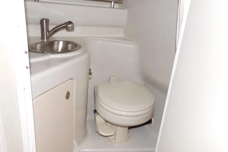 Slide: The Image of 2009 Searay Sundancer boat bathroom with compact toilet and stainless steel sink. - 15