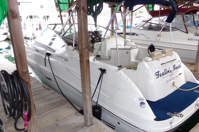 Slide: The Image of 2009 Searay Sundancer boat docked, featuring sleek design and comfortable seating. - 3