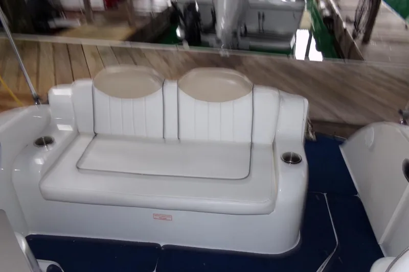Slide: The Image of 2009 Searay Sundancer boat interior with white seating and cup holders. - 5