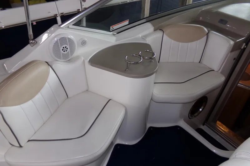 Slide: The Image of 2009 Searay Sundancer interior seating with cup holders and speaker system. - 6