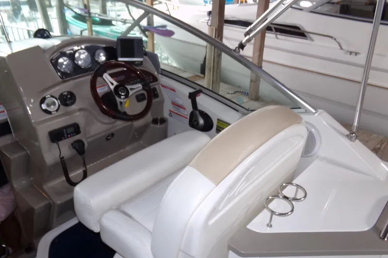 Slide: The Image of 2009 Searay Sundancer boat cockpit with steering wheel and control panel. - 8