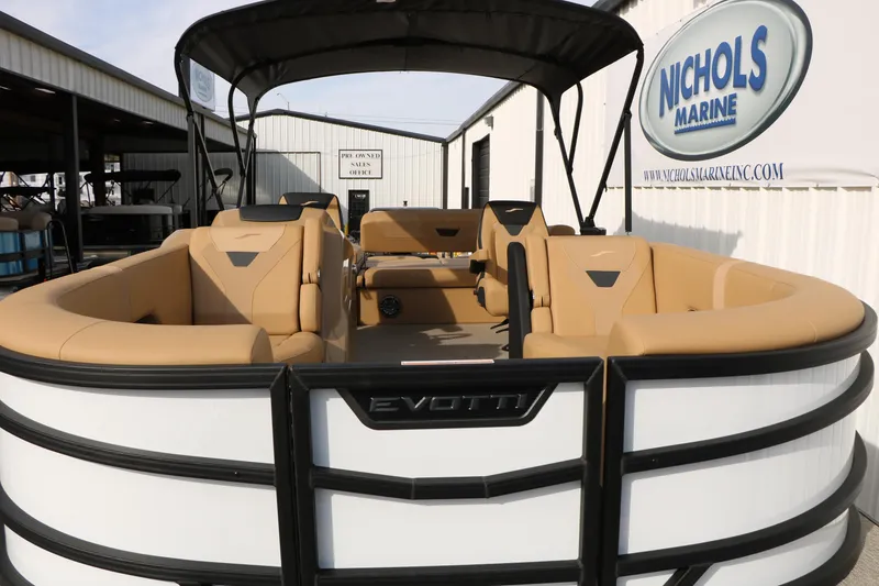 Slide: The Image of 2026 Evotti 523CS pontoon boat with tan seating at Nichols Marine dealership. - 15