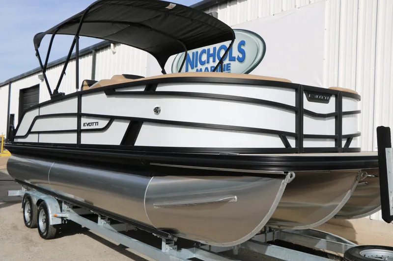 Slide: The Image of 2026 Evotti 523CS pontoon boat on trailer, featuring sleek design and canopy. - 2
