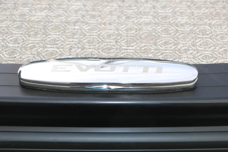 Slide: The Image of Chrome Evotti logo on 2026 Evotti 523CS vehicle, textured background. - 45