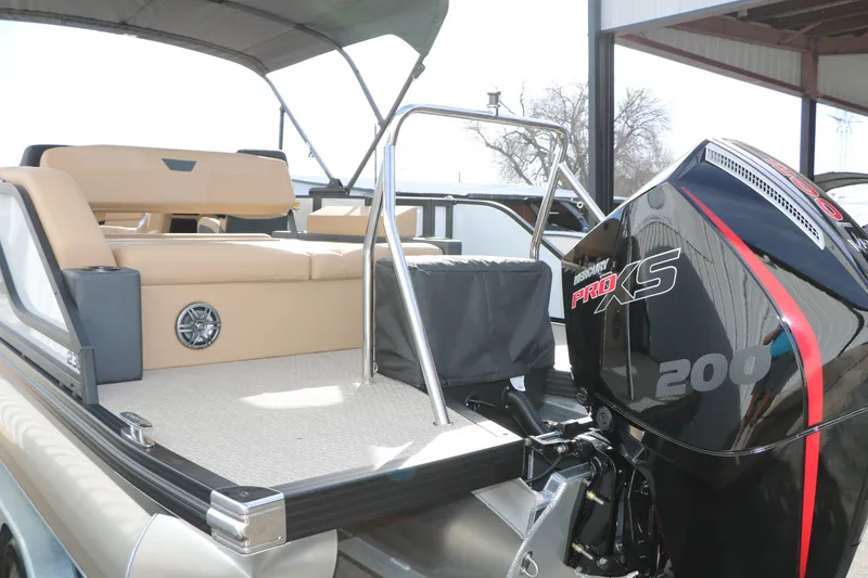 Slide: The Image of 2026 Evotti 523CS boat with Mercury Pro XS 200 engine, beige seating, and canopy. - 5