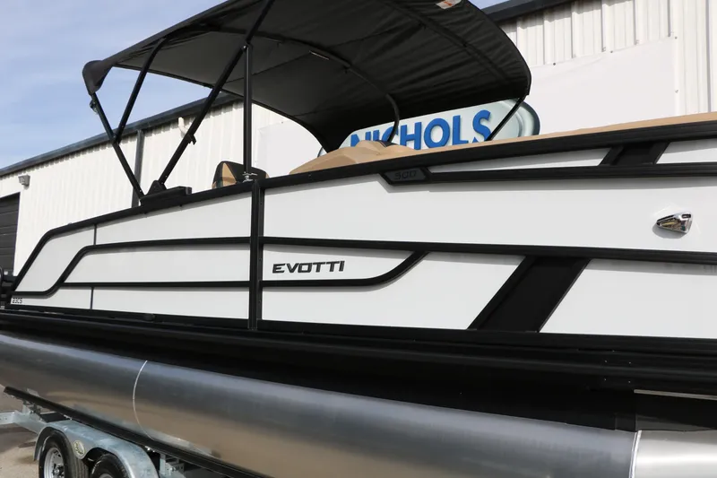 Slide: The Image of 2026 Evotti 523CS pontoon boat with sleek design and canopy, displayed outdoors. - 51