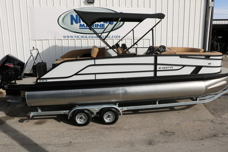 Slide: The Image of 2026 Evotti 523CS pontoon boat on trailer, parked outside marine dealership. - 7