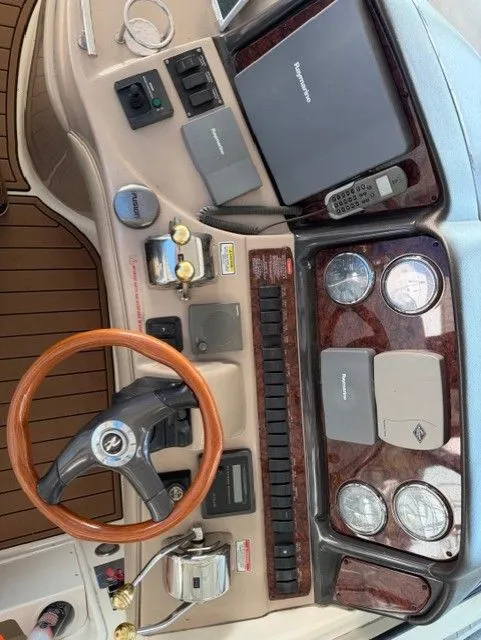 Slide: The Image of Sea Ray 420 Sundancer 2004 helm with wood steering wheel and instruments. - 13