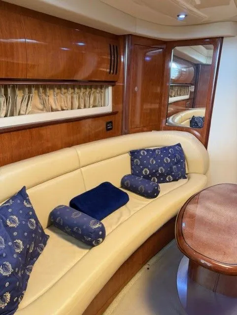Slide: The Image of Interior of 2004 Sea Ray 420 Sundancer with leather sofa and wooden table. - 18