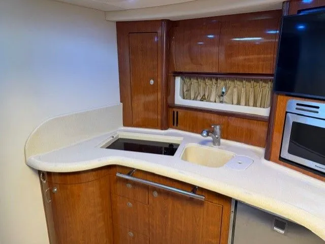 Slide: The Image of Interior of 2004 Sea Ray 420 Sundancer with kitchen area. - 19