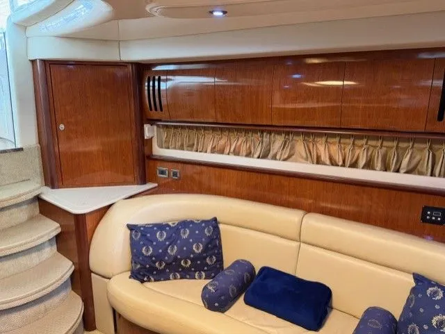 Slide: The Image of Interior of 2004 Sea Ray 420 Sundancer with leather sofa and wood cabinetry. - 21