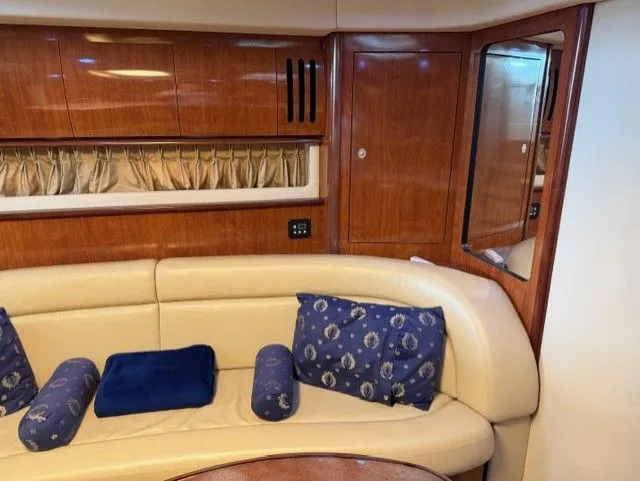 Slide: The Image of Interior of 2004 Sea Ray 420 Sundancer with leather sofa and wood cabinetry. - 24