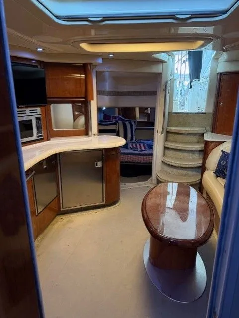 Slide: The Image of Interior of 2004 Sea Ray 420 Sundancer with kitchen and seating area. - 25