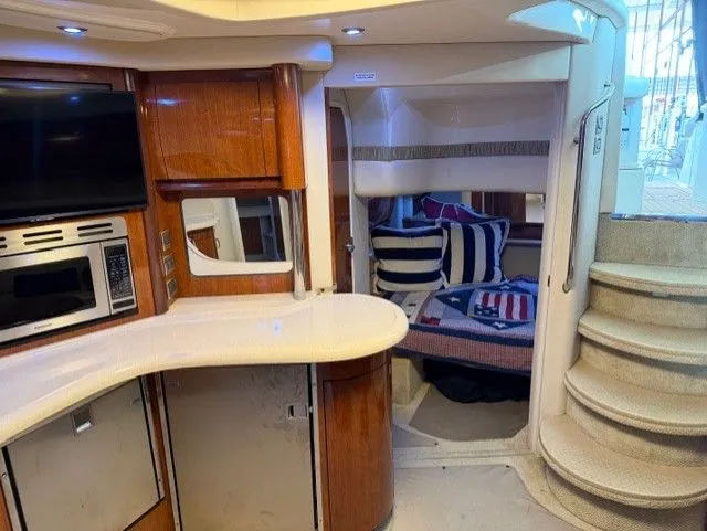 Slide: The Image of Interior of a 2004 Sea Ray 420 Sundancer yacht with kitchen and sleeping area. - 28