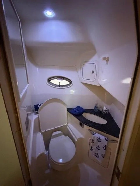 Slide: The Image of 2004 Sea Ray 420 Sundancer bathroom with toilet and sink. - 35