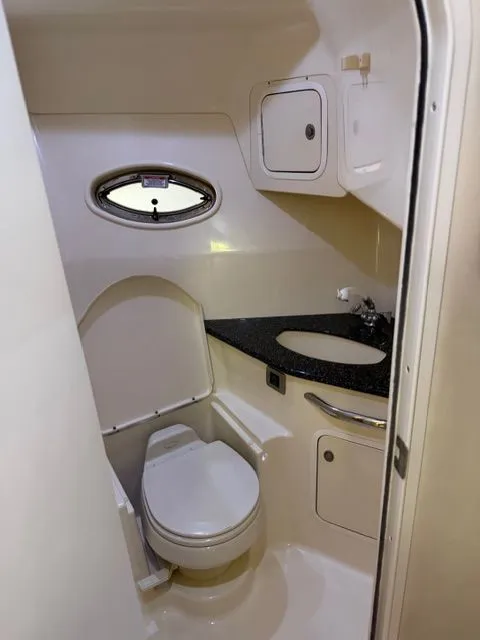 Slide: The Image of 2004 Sea Ray 420 Sundancer bathroom with toilet and sink. - 36