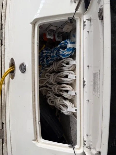 Slide: The Image of Storage compartment on 2004 Sea Ray 420 Sundancer with ropes and accessories. - 38