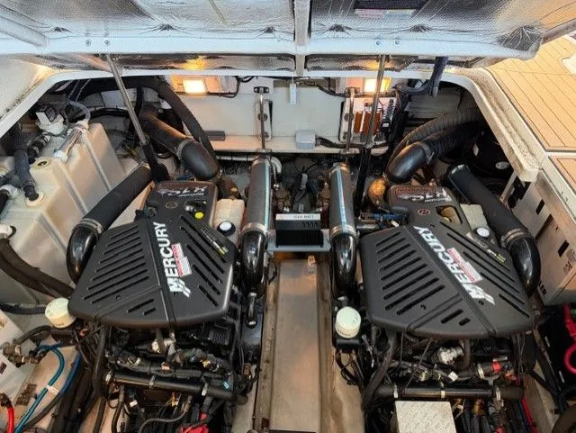 Slide: The Image of Engine room of 2004 Sea Ray 420 Sundancer with twin Mercury engines. - 42