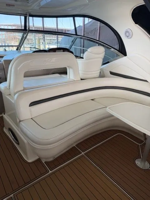 Slide: The Image of Interior of a 2004 Sea Ray 420 Sundancer yacht with white leather seating. - 9