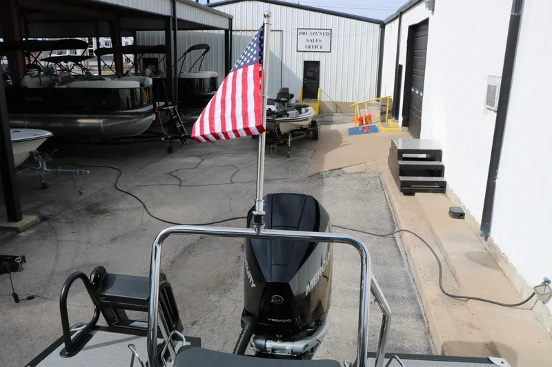 Slide: The Image of American flag on Evotti 723QL boat, 2026 model, near pre-owned sales office. - 33