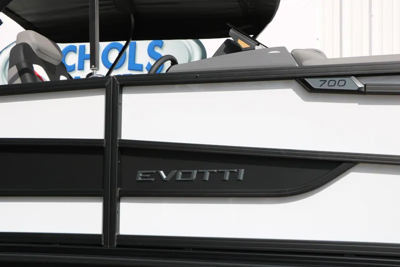 Slide: The Image of 2026 Evotti 723QL boat, sleek black and white design, partial view with branding. - 5