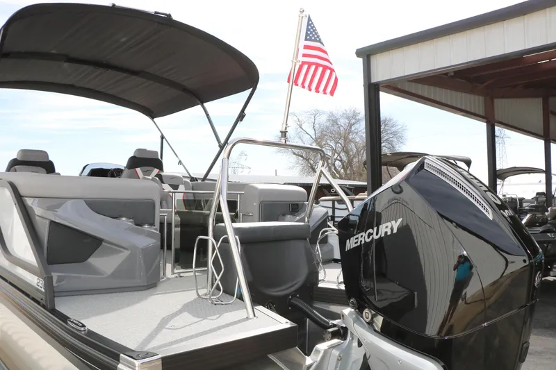 Slide: The Image of 2026 Evotti 723QL boat with Mercury engine and American flag in marina setting. - 6