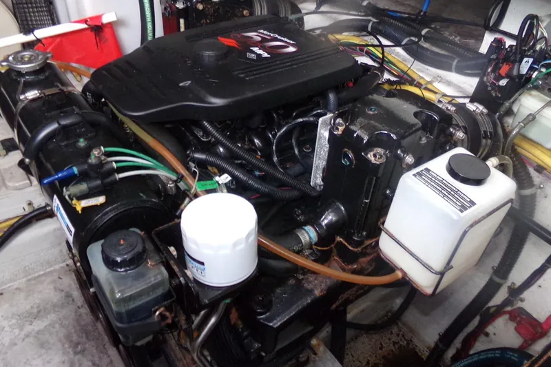 Slide: The Image of Engine compartment of a 2006 Bayliner 325 boat, showcasing detailed mechanical components. - 10
