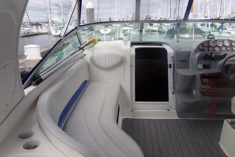 Slide: The Image of Interior view of 2006 Bayliner 325 boat with seating and control panel in marina. - 18