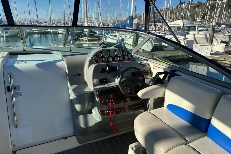 Slide: The Image of 2006 Bayliner 325 boat cockpit with steering wheel and marina view. - 20