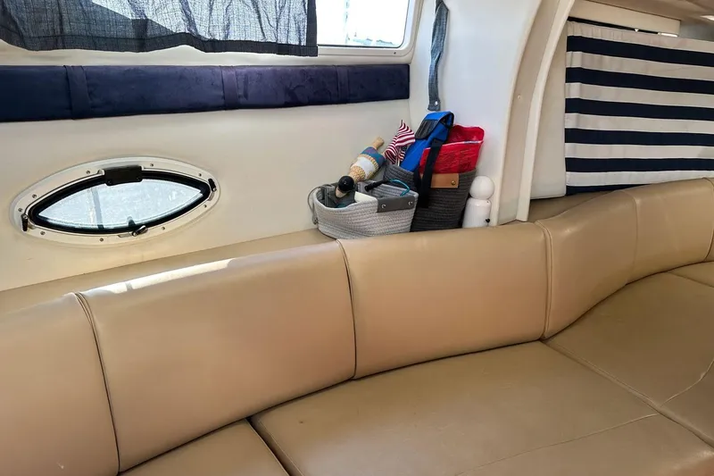 Slide: The Image of Interior of a 2006 Bayliner 325 boat with beige seating and storage baskets. - 24