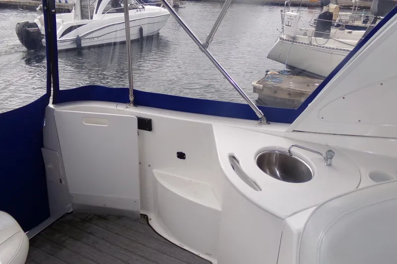 Slide: The Image of 2006 Bayliner 325 boat interior with sink, docked at marina. - 8