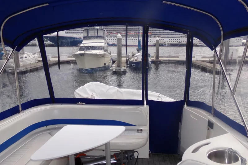 Slide: The Image of Interior view of 2006 Bayliner 325 yacht with marina backdrop. - 9
