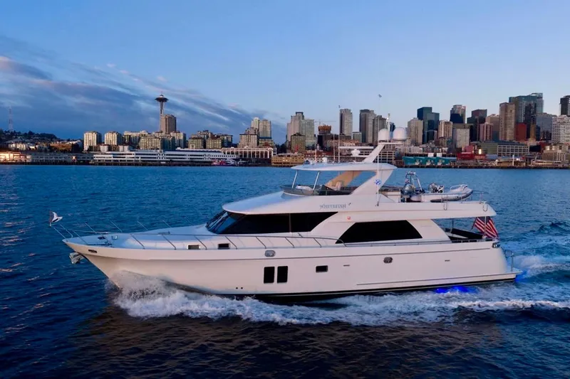 The Image of Luxury 2013 Ocean Alexander 72 Pilothouse yacht cruising near city skyline at sunset. - 0
