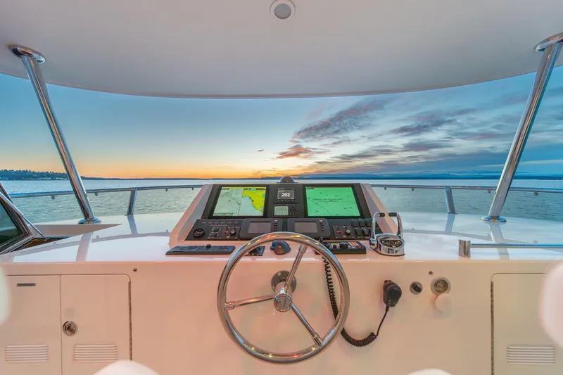 Slide: The Image of Pilothouse view from 2013 Ocean Alexander 72, showcasing sunset over calm waters. - 10