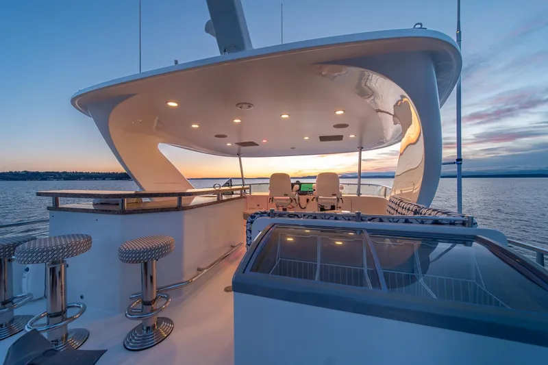 Slide: The Image of Luxurious 2013 Ocean Alexander 72 Pilothouse yacht at sunset, featuring elegant outdoor seating. - 11