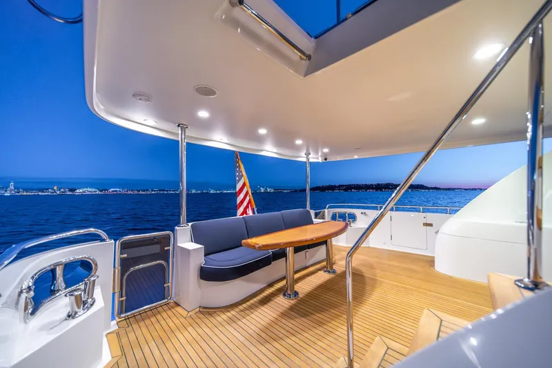 Slide: The Image of Luxurious 2013 Ocean Alexander 72 Pilothouse yacht deck at sunset, featuring elegant seating and ocean views. - 15