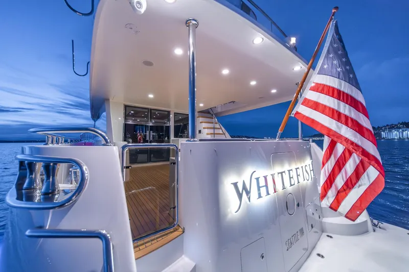 Slide: The Image of Ocean Alexander 72 Pilothouse yacht, 2013 model, with American flag at sunset. - 17