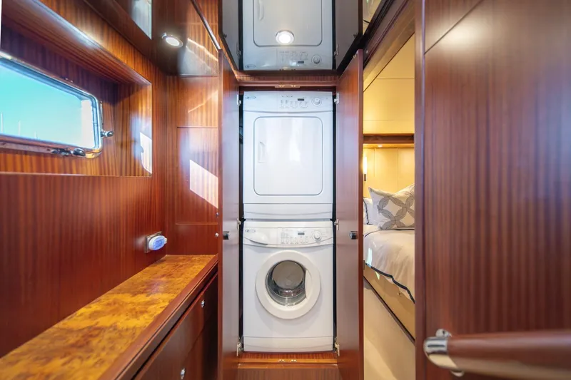Slide: The Image of Laundry area in 2013 Ocean Alexander 72 Pilothouse yacht with wood paneling and bedroom view. - 31