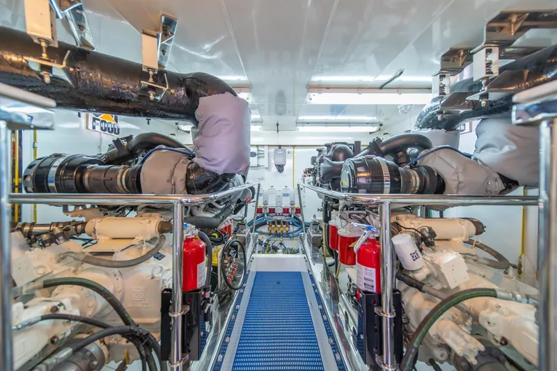 Slide: The Image of Engine room of 2013 Ocean Alexander 72 Pilothouse yacht, featuring dual engines and fire extinguishers. - 37