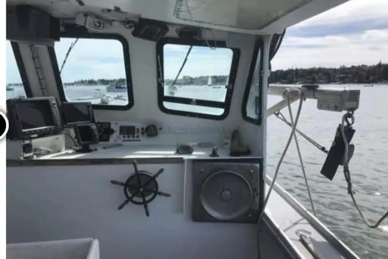 Slide: The Image of Interior of a 1986 BGM Custom boat with navigation equipment and scenic water view. - 6