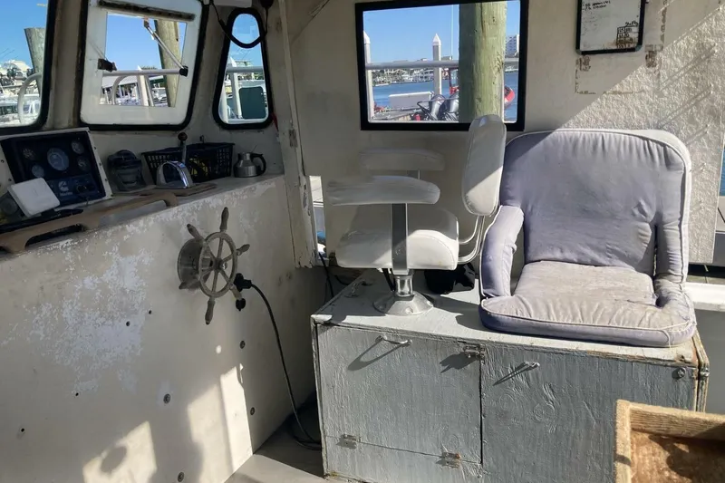Slide: The Image of Interior of 1986 BGM Custom boat with steering wheel and cushioned seats. - 26