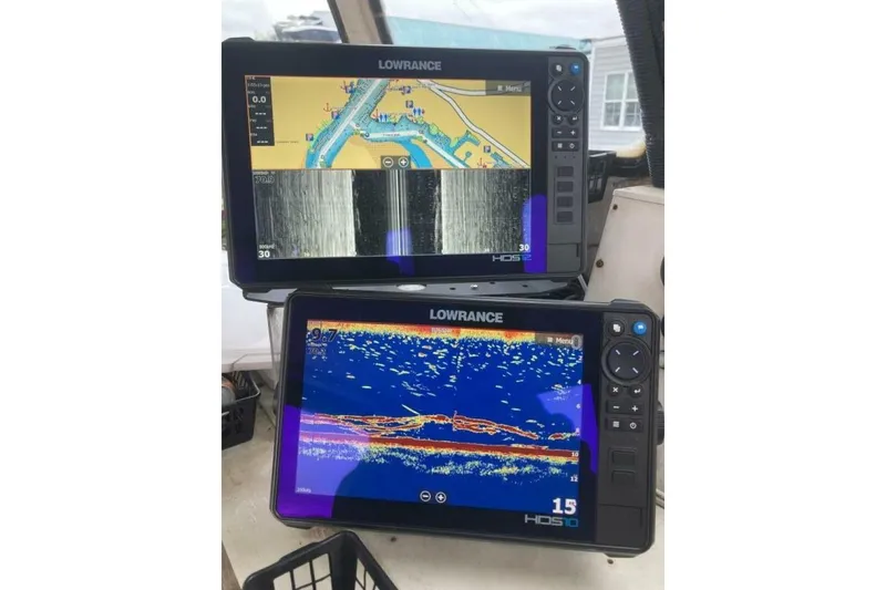 Slide: The Image of Two Lowrance HDS displays showing sonar and navigation data on a BGM Custom 1986 boat. - 30